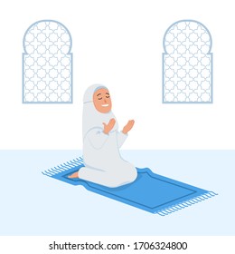 Moslem female sit and pray near decorative window.