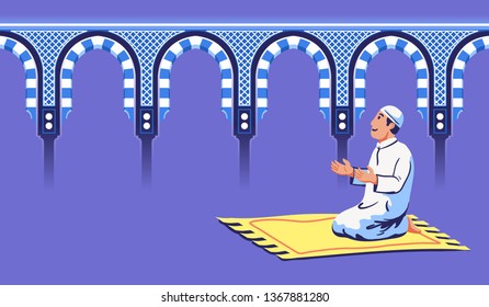 Moslem male sit and pray near decorative mosque gate.