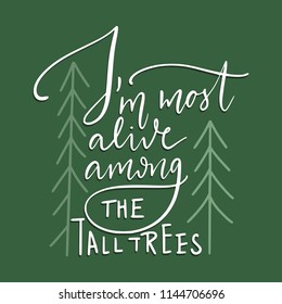 I'm most alive among the tall trees. Camping hand drawn lettering quote. Vector wanderlust card.