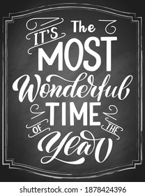 It's the most wonderful time of the year brush hand lettering, on blackboard background. Vector type chalk illustration. Can be used for holidays festive design.