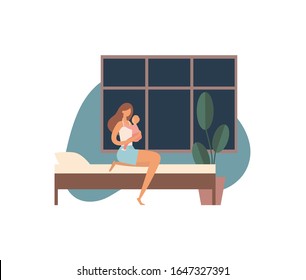 Mother with baby going to bed. Barefoot woman in pajama hugging baby and sitting on comfortable bed near potted plant and window before going to sleep at night at home