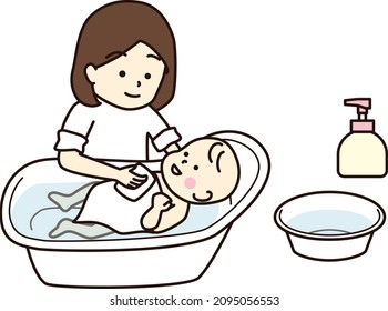 Madre bañando a su bebé en un baño de bebé.