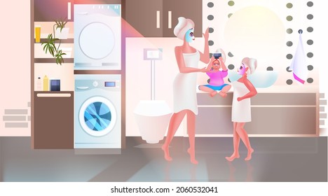 mother with children applying masks happy family spending time together bathroom interior