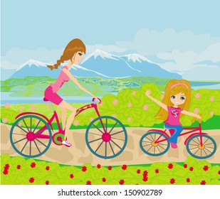 Mother and daughter biking in the park