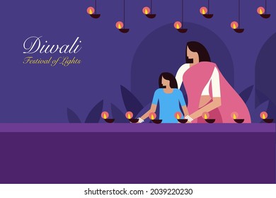 A mother and daughter decorating their home with Diwali oil lamps.Concept for Diwali festival in India