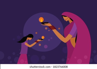 A mother and daughter wearing traditional dress holding Diwali festival lamps.Concept for Diwali festival in India