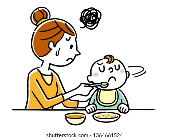 Mother giving food to baby