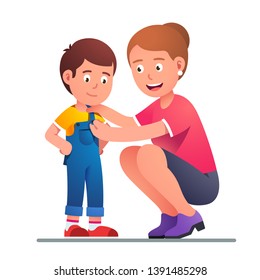 Mother helping boy son to dress up or change clothes. Parent button up kid jumpsuit. Parenting undressing or dressing up happy smiling child. Flat vector character illustration