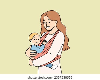 Mother holds baby in carrier sling and smiles, taking care of son and using comfortable babywearing. Caring happy woman with newborn, recommends purchasing sling for young mothers.