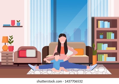 mother with kid doing physical exercise at home sportswoman engaged in fitness or yoga with baby son healthy lifestyle concept modern living room interior flat full length horizontal