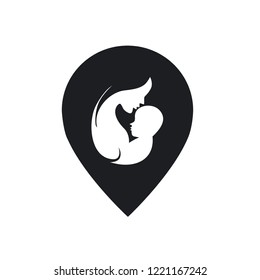 Mother kissing little baby with pin shaped silhouette in paper cut style