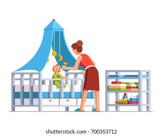 Mother playing rattle to little baby son toddler sitting in crib bed or cot. Woman babysitter looking after newborn boy. Mum and child in kids room. Family childcare. Flat cartoon vector illustration.