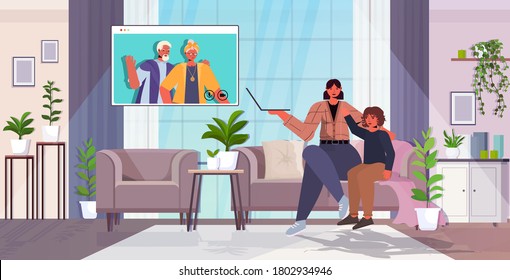 mother and son having virtual meeting with grandparents in web browser window during video call family chat communication concept living room interior horizontal full length vector illustration