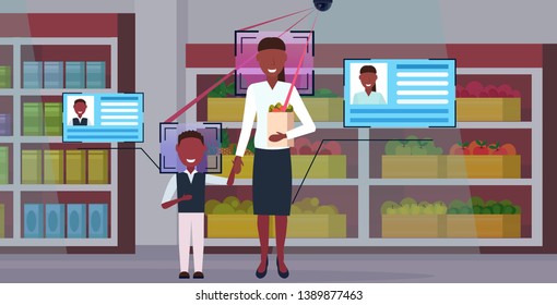 mother and son holding shopping paper bag with groceries customers identification facial recognition concept security camera surveillance cctv system grocery shop interior full length horizontal