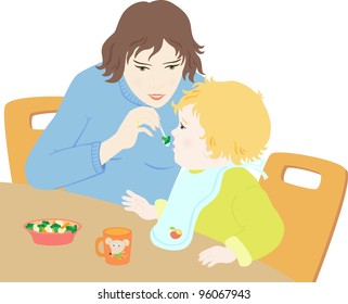 Mother spoon-feeds the child