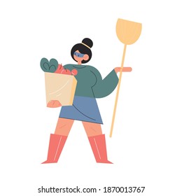 Mother in superhero mask standing with shopping bag and household in hands