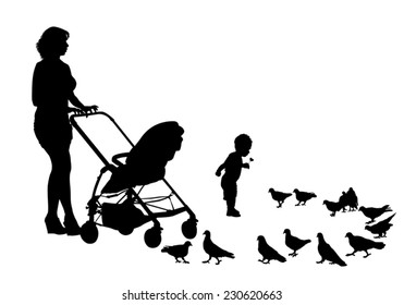 Mother walks with the kids and a stroller for a walk. Mother and child feeding pigeons
