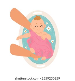 Mother washes her baby in bathroom. Baby girl taking bath with flowers. Mom bathing kid, child in small tub. Kids hygiene.