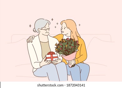 Mothers day holiday, women in family concept. Beautiful young woman and her mother with flowers and present box sitting and hugging at home, feeling care and love vector illustration