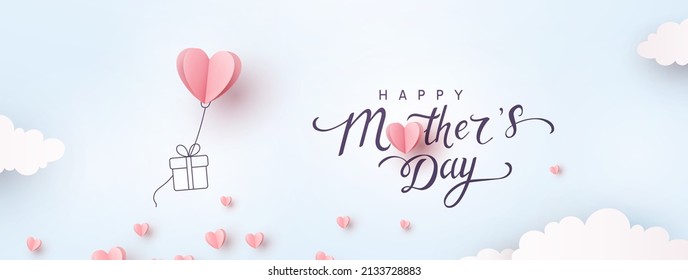 Mother's day postcard with paper flying elements and gift box on blue sky background. Vector symbols of love in shape of heart for greeting card design - Shutterstock ID 2133728883