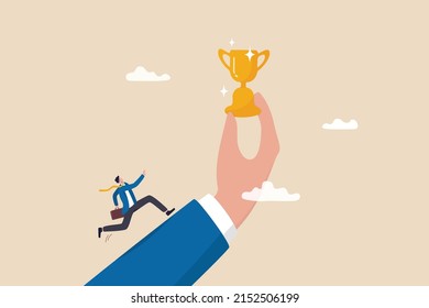 Motivation To Achieve Goal, Small Win To Motivate Employee To Succeed In Work, Effort And Ambition To Reach Target Concept, Businessman Run With Full Effort To Reach Trophy Cup In Giant Hand.