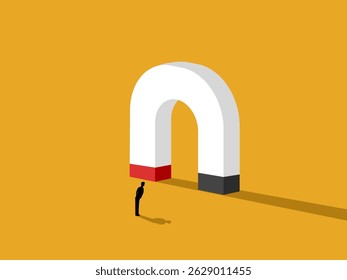 Motivation, man standing looking at large magnet