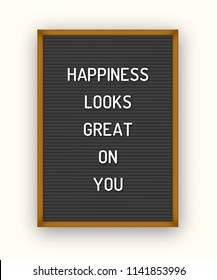 Motivation quote on black letterboard with white plastic letters. Hipster vintage inspirational poster 80x, 90x. Happiness looks great on you