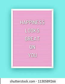 Motivation quote on pink letterboard with white plastic letters. Hipster vintage inspirational poster 80x, 90x. Happiness looks great on you