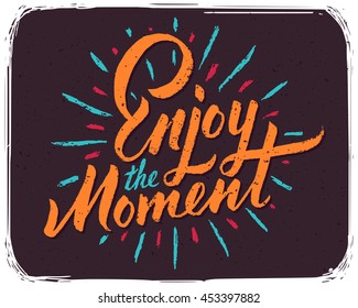 Motivational positive print for t-shirt with lettering calligraphic text composition "Enjoy the moment"