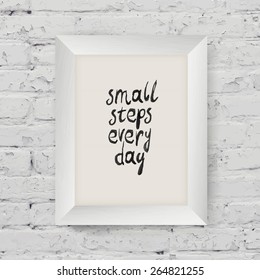 Motivational poster "small steps every day" in the art wooden frame on on white brick wall