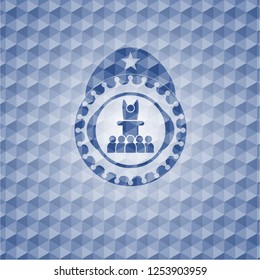 motivational speech icon inside blue emblem with geometric background.
