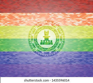 motivational speech icon inside emblem on mosaic background with the colors of the LGBT flag