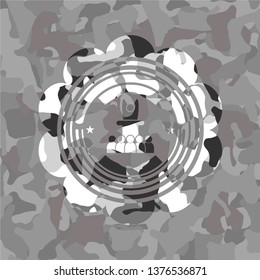 motivational speech icon inside grey camouflaged emblem