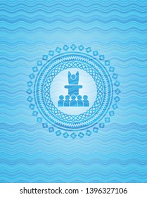 motivational speech icon inside light blue water emblem.