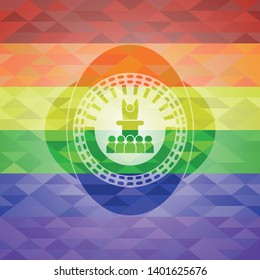 motivational speech icon on mosaic background with the colors of the LGBT flag