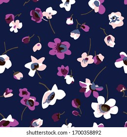 Motley contrasting colorer small wildflowers on dark blue background. Vector seamless pattern for textile printing.