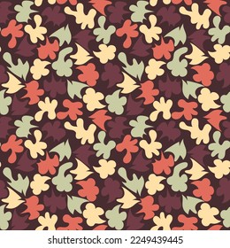 Motley seamless pattern in warm colors. Multi-colored abstract shapes are randomly located on a dark background. Vector.