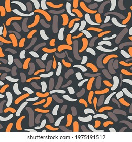 motley spotted seamless pattern. orange, brown, gray abstract rounded curved shapes randomly arranged on a black background. vector
