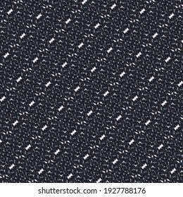 Motley textured pattern, in blue and black, with flecks and white markings. Blanket or bedspread.