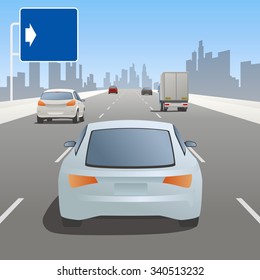 motor vehicles driving on highway and road sign