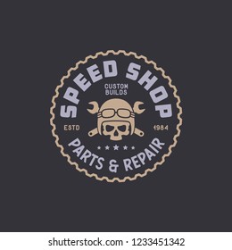 Motorcycle speedshop t-shirt design. Skull with crossed wrenches. Motorcycles repair service emblem badge label. Vector vintage illustration.