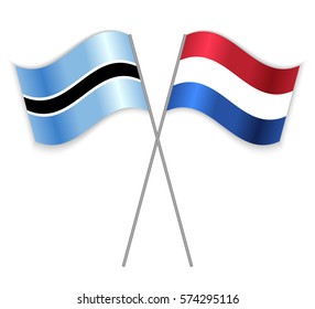 Motswana and Dutch crossed flags. Botswana combined with Netherlands isolated on white. Language learning, international business or travel concept.