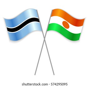 Motswana and Nigerien crossed flags. Botswana combined with Niger isolated on white. Language learning, international business or travel concept.