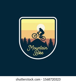 mountain bike badge jump silhouette yellow sky background. logo sign patch design