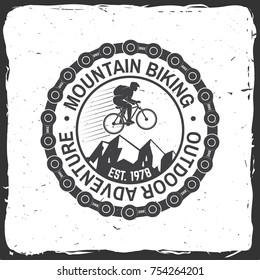 Mountain biking. Vector illustration. Concept for shirt or logo, print, stamp or tee. Vintage typography design with man riding bike, chain and mountain silhouette. Outdoor adventure.