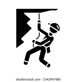 Mountain climbing glyph icon. Alpinism, mountaineering. Abseiling, rappelling descend. Spelunking. Mountaineer sliding down rope. Silhouette symbol. Negative space. Vector isolated illustration