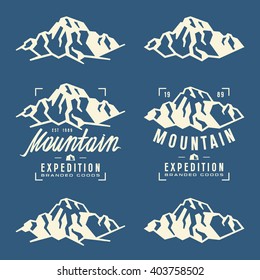 Mountain expedition labels, badges and design elements. White print on blue background