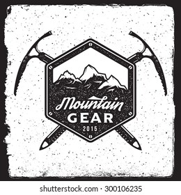 mountain gear vintage emblem. logotype template with mountains, ice axe. outdoor activity symbol with ink stamp texture