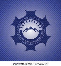 mountain icon inside badge with denim texture