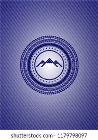 mountain icon inside badge with jean texture